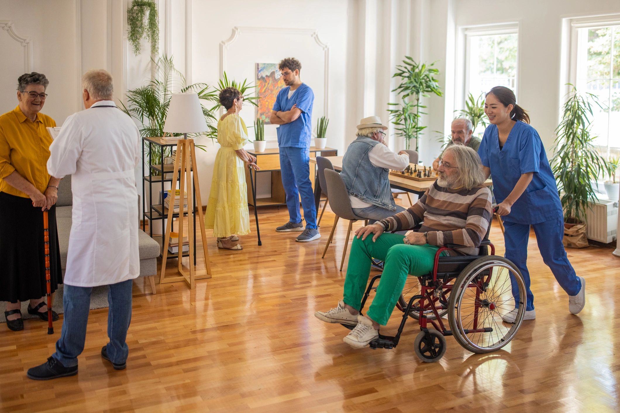 Care team supporting residents in a nursing and rehabilitation center common area