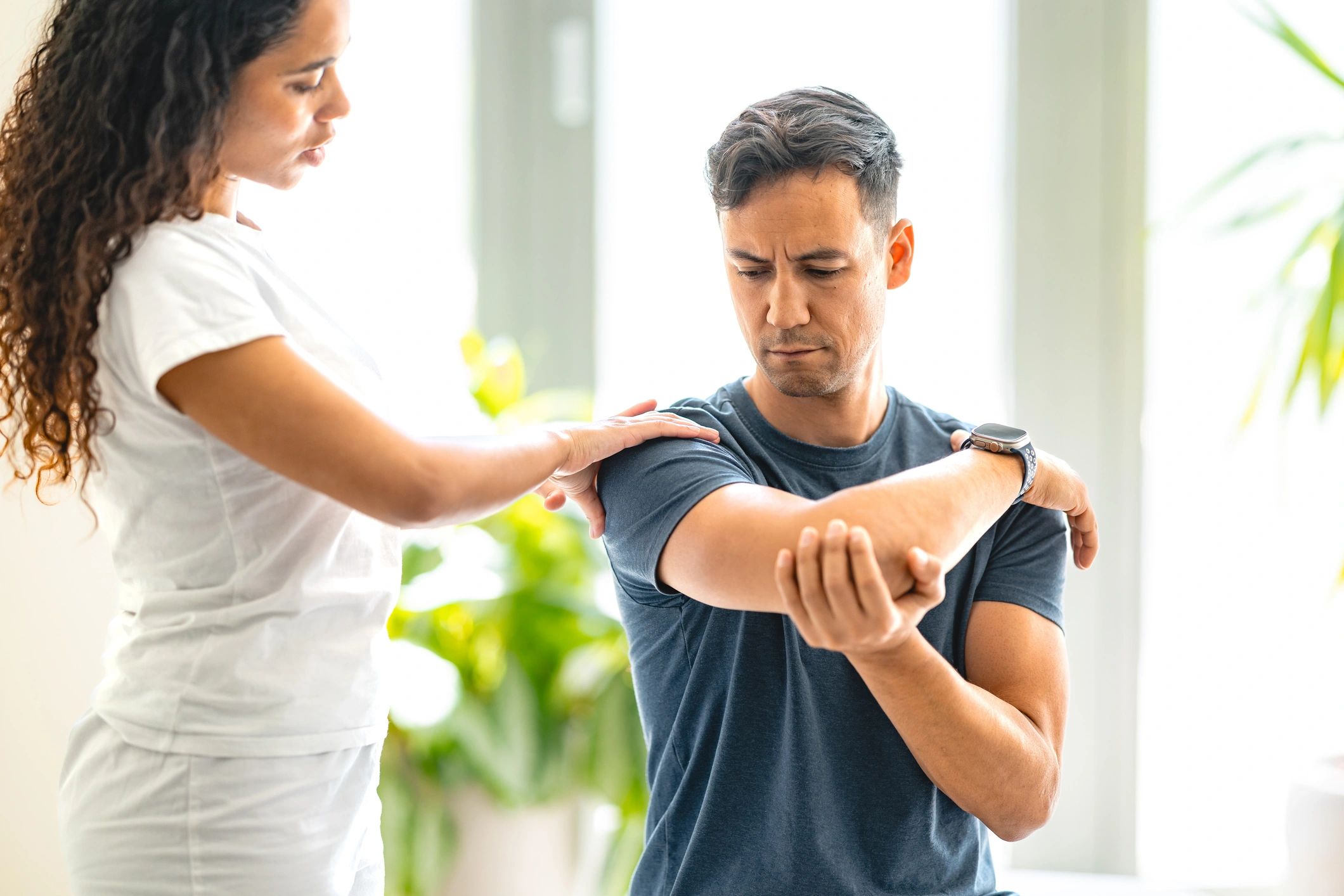 Therapist guiding a patient during rehabilitation session